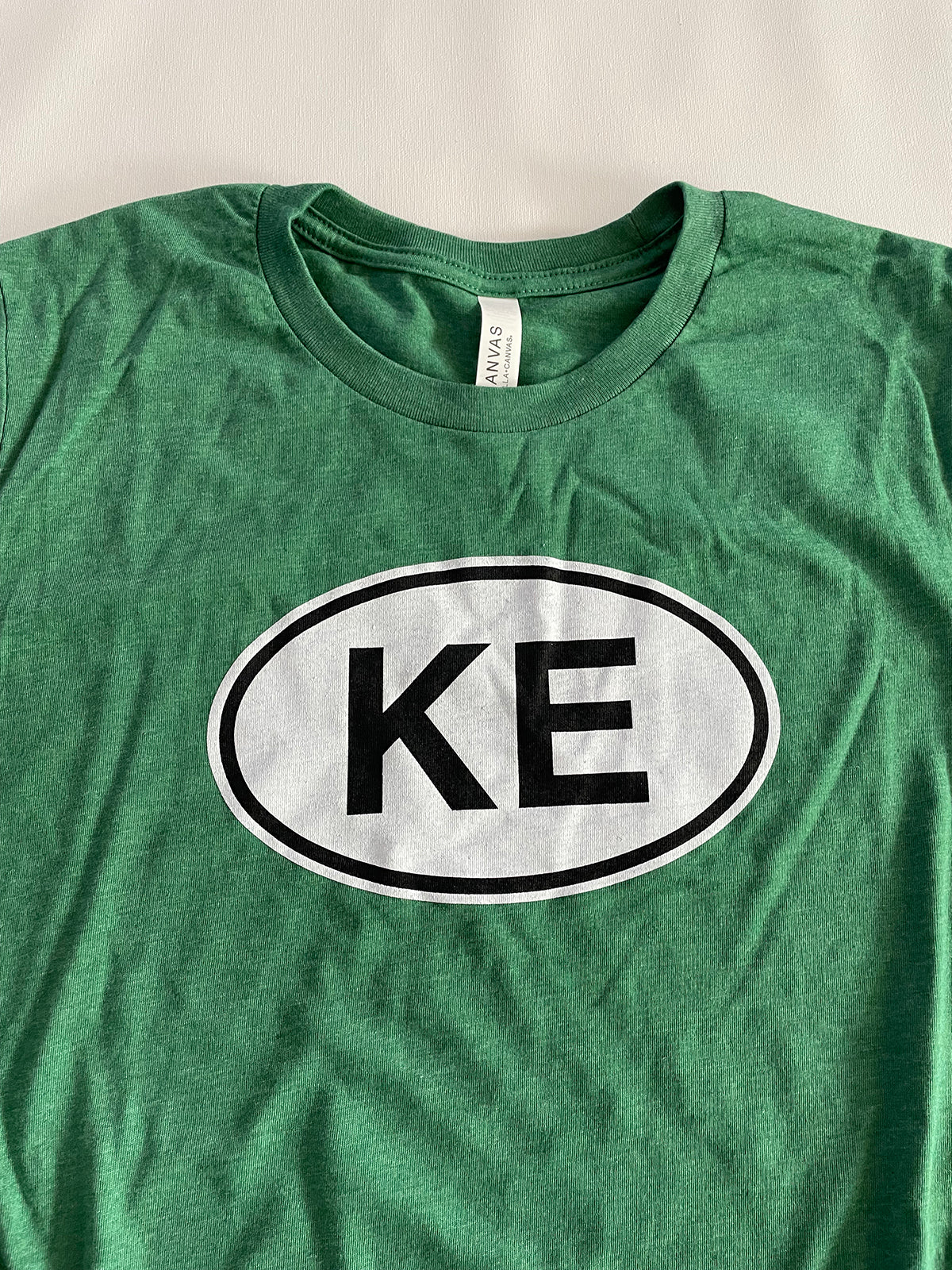 KE oval green tee